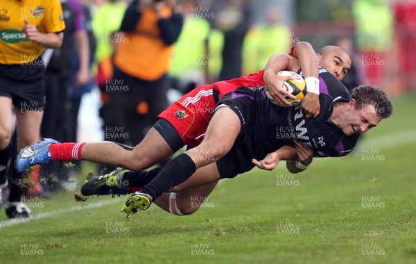 14.05.11 - Musnter v Ospreys... Ospreys Ashley Beck is tackled by Simon Zebo.. 