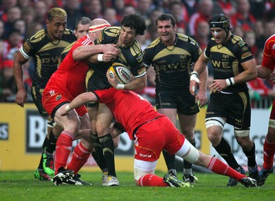 24.04.10  Munster v Ospreys... Ospreys' Mike Phillips tackled by John Hayes and James Coughlan of Munster. 