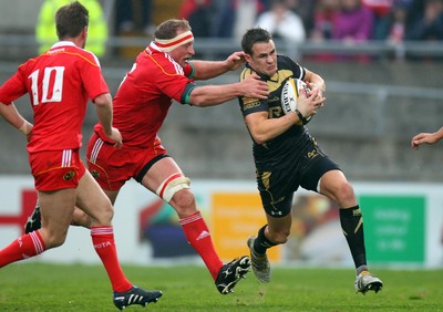 24.04.10  Munster v Ospreys... Osprey's Lee Byrne tries to go past Mick O'Driscoll of Munster. 