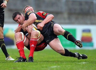 24.04.10  Munster v Ospreys... Ospreys' Huw Bennett tackled by Mick O'Driscoll of Munster. 