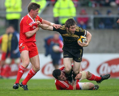 24.04.10  Munster v Ospreys... Ospreys' Andrew Bishop tackled by Ronan O'Gara and James Coughlan of Munster. 