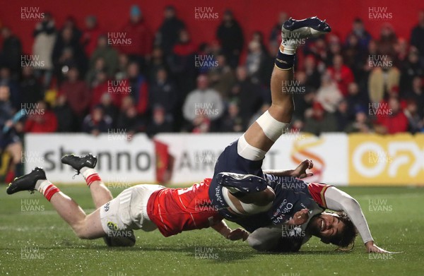 030323 - Munster v Scarlets - United Rugby Championship - Vaea Fifita of Scarlets scores his sides second try despite the tackle of Patrick Campbell of Munster
