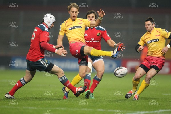 101014 - Munster v Scarlets - Guinness PRO12 -Liam Williams kicks the ball away from Johne Murphy and Gerhard van den Heever