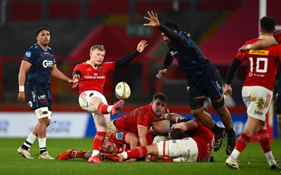 150225 - Munster v Scarlets - United Rugby Championship - Ethan Coughlan of Munster is charged down by Sam Lousi of Scarlets