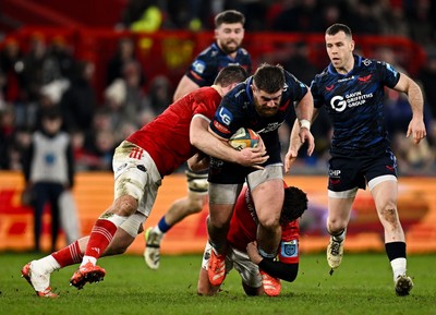 150225 - Munster v Scarlets - United Rugby Championship - Kemsley Mathias of Scarlets is tackled by Munster players Jack O'Donoghue, left, and Billy Burns