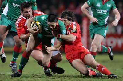 18.03.10 Munster v Scarlets... Munster's Ian Dowling and Julien Brugnaut tackle Regan King of Llanelli Scarlets. 