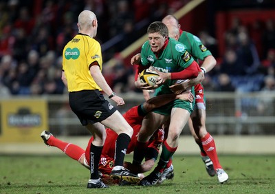 18.03.10 Munster v Scarlets... Munster's Mick O'Driscoll and Peter Stringer tackle Rhys Priestland of Llanelli Scarlets. 