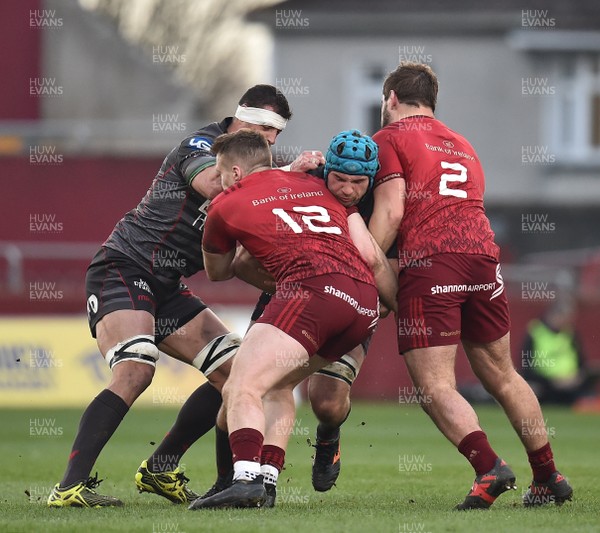 240318 - Munster v Scarlets - Guinness PRO14 -  Tadhg Beirne of Scarlets is tackled by Rory Scannell, left, and Rhys Marshall of Munster 