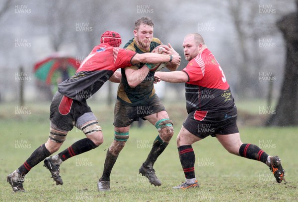 100318  - Nant Conwy v Maesteg Harlequins - WRU National Bowl Quarter Final - Ifan Pyrs is tackled by Mathew Tidball and Dean Ronnan of Maesteg Quins