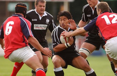 270903 - Neath-Swansea Ospreys v Munster - Celtic League - Ospreys' Elvis Seveali'i hands off Jason Jones-Hughes