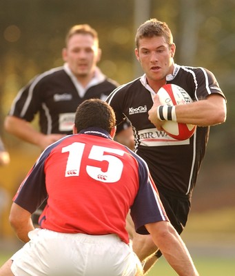 270903 - Neath-Swansea Ospreys v Munster - Celtic League - Ospreys' James Storey takes on Jeremy Staunton