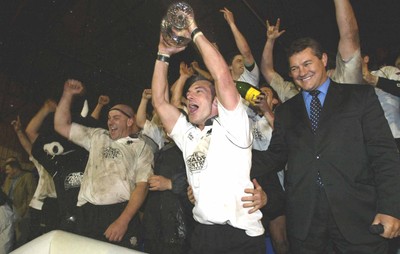 270405Neath v BedwasNeaths Gareth Morris celebrates with the team after being presented with the Premier League Trophy by David Pickering