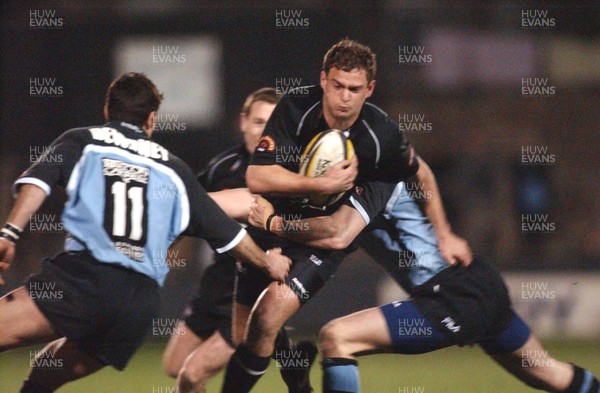 120303 - Neath v Cardiff - Welsh Premiership - Neath's Adrian Durston Takes on Jamie Robinson and Dean Dewdney (left)