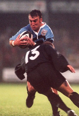 230897 - Neath v Cardiff - Gareth Jones of Cardiff is tackled by David Hawkins