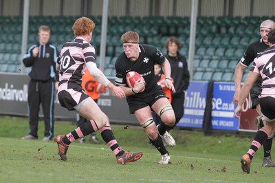 250212 - Neath v Cardiff - Welsh Premiership - Euros Evans of Neath looks for a way past Rhys Patchell of Cardiff