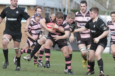 250212 - Neath v Cardiff - Welsh Premiership - Tom Young of Cardiff is help by the Neath defence