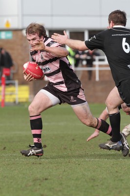 250212 - Neath v Cardiff - Welsh Premiership - Kristian Dacey of Cardiff looks for a way past Gareth Gravell of Neath