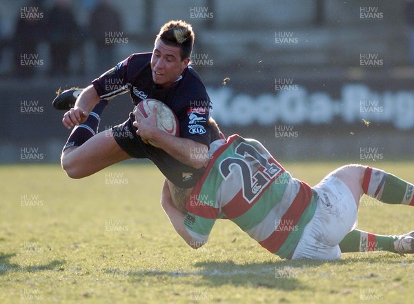 250206 - Neath RFC v Ebbw Vale RFC - Principality Permiership - The Gnoll - Neath's Gareth James is tackled by Dan Phillips 