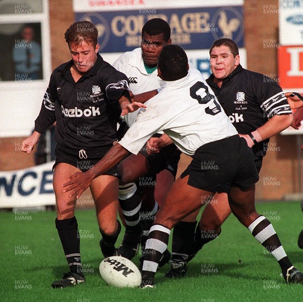 251095 - Neath RFC v Fiji - Patrick Horgan of Neath breaks past Sekoue Rauluni