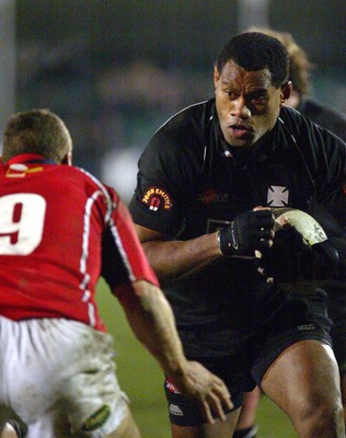 140203 - Neath v Llanelli - Welsh Premiership - Neath's Alfie Mocelutu bears down on Rob Walters