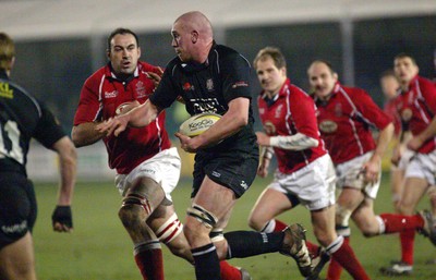 140203 - Neath v Llanelli - Welsh Premiership - Neath's Lyndon Bateman breaks past Chris Wyatt