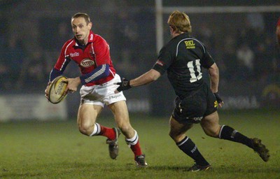 140203 - Neath v Llanelli - Welsh Premiership - Llanelli's Wayne Proctor takes on Shane Williams