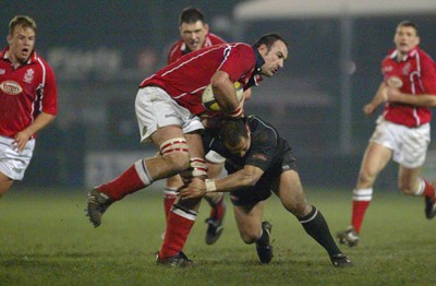 140203 - Neath v Llanelli - Welsh Premiership - Llanelli's Chris Wyatt is tackled by Dave Tiueti