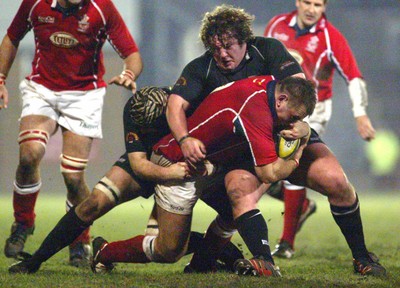 140203 - Neath v Llanelli - Welsh Premiership - Llanelli's Aled Gravell is tackled by Steve Tandy and Adam Jones