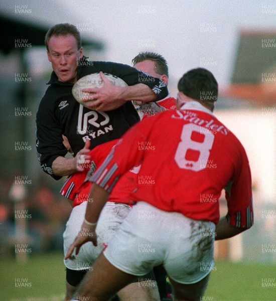 201193 - Neath v Llanelli - Paul Thorburn of Neath is tackled by Ian Jones and Emyr Lewis of Llanelli