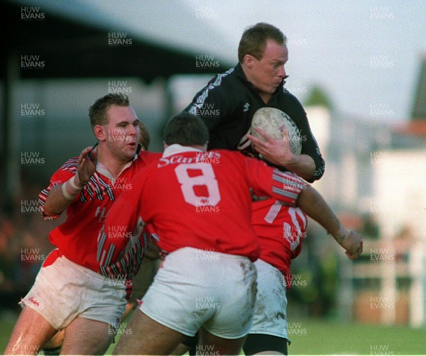 201193 - Neath v Llanelli - Paul Thorburn of Neath is tackled by Ian Jones, Emyr Lewis and Scott Quinnell of Llanelli