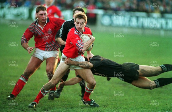 201193 - Neath v Llanelli - Wayne Proctor of Llanelli is tackled by Chris Bridges of Neath