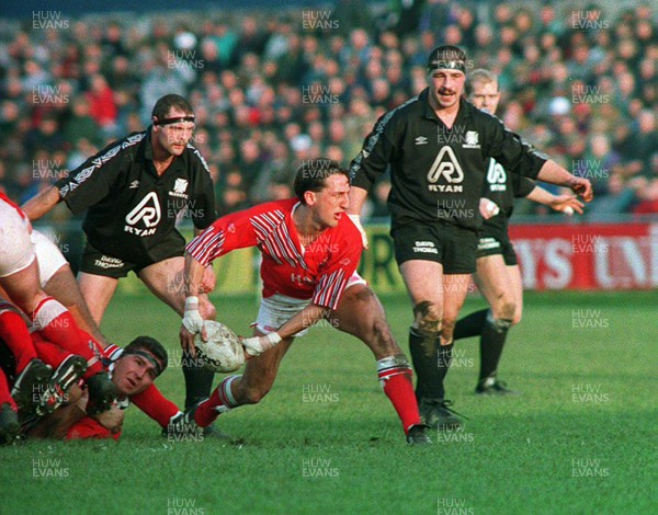 201193 - Neath v Llanelli - Rupert Moon of Llanelli passes the ball out