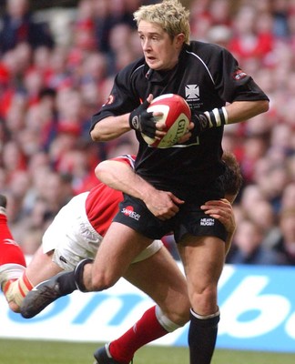 010203 - Neath v Munster - Celtic League Final - Neath's Shane Williams is tackled by Mossie Lawlor