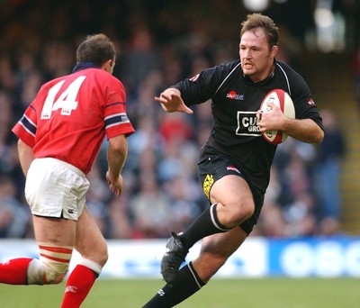 010203 - Neath v Munster - Celtic League Final - Neath's Nathan Bonner-Evans holds off John Kelly