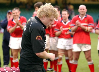 010203 - Neath v Munster - Celtic League Final - Neath's Duncan Jones collects his medal as Munster applaud