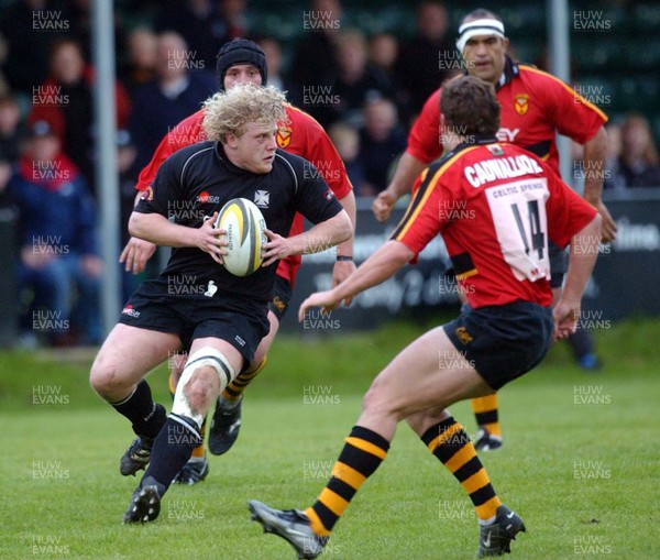 230503 - Neath v Newport - Welsh Premiership - Neath's Duncan Jones tries to get past Alex Cadwallader 