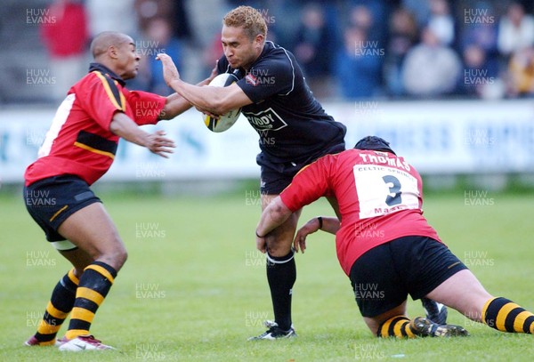 230503 - Neath v Newport - Welsh Premiership - Neath's Dave Tiueti is caught by Nathan Brew (left) and Rhys Thomas (rt)