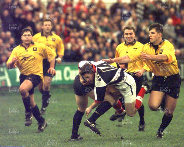 061297 - Neath v Pontypridd - Gareth Wyatt of Pontypridd is tackled by Patrick Horgan