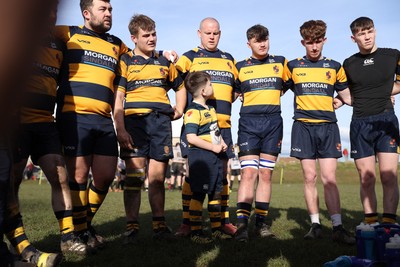 010325 - Nelson Nomads v Aberdare Athletic - WRU Athletic Mid District Division A - A young boy looks up at senior players during Aberdare�s team huddle