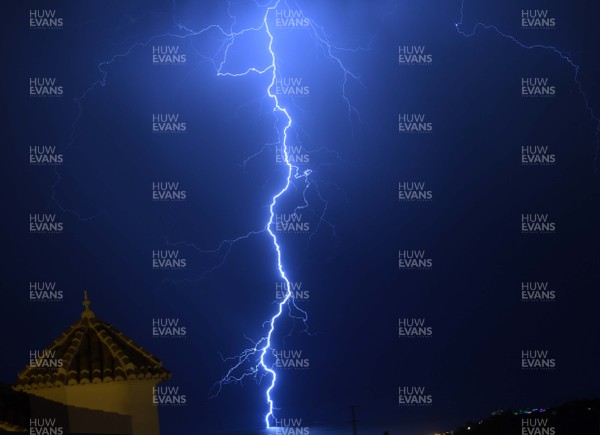 120719 - Weather -  Lightning hits the sea off the coast of Nerja on the Costa del Sol in Spain looking towards North Africa 