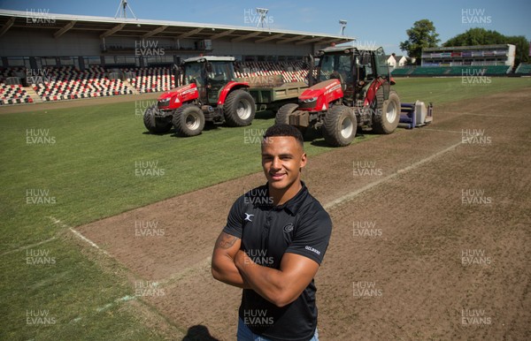 050717 - Dragons rugby star Ashton Hewitt takes a closer look as work starts on removal of the old pitch at Rodney Parade, Newport, in preparation for the installation of a new hybrid pitch