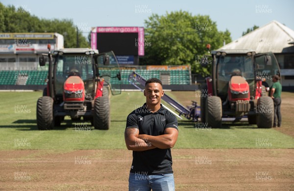 050717 - Dragons rugby star Ashton Hewitt takes a closer look as work starts on removal of the old pitch at Rodney Parade, Newport, in preparation for the installation of a new hybrid pitch