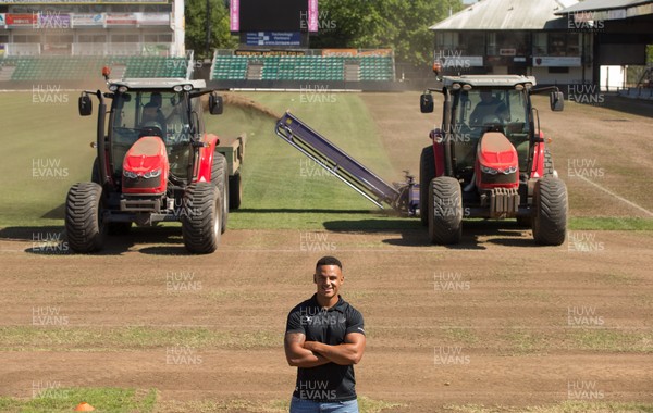 050717 - Dragons rugby star Ashton Hewitt takes a closer look as work starts on removal of the old pitch at Rodney Parade, Newport, in preparation for the installation of a new hybrid pitch