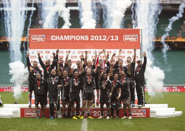 120513 - New Zealand - HSBC Sevens World Series -  Champions -Tim Mikkleson and Tomasi Cama lift the trophy as New Zealand are crowned series champions after a convincing win over Australia at Twickenham