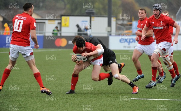 170619 - New Zealand U20 v Wales U20 - World Rugby Under 20 Championship - 5th Place Semi-Final -  Ioan Davies of Wales is tackled by Dallas McLeod