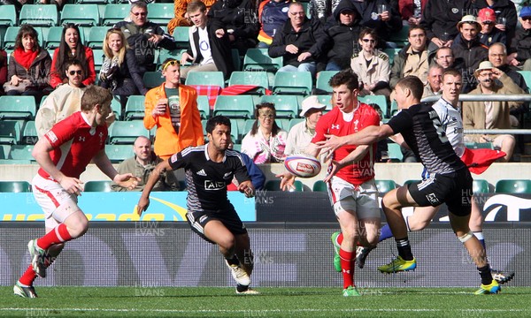 110513 - New Zealand v Wales - IRB Sevens England - Owen Jenkins of Wales offloads the ball moments before he is tackled 