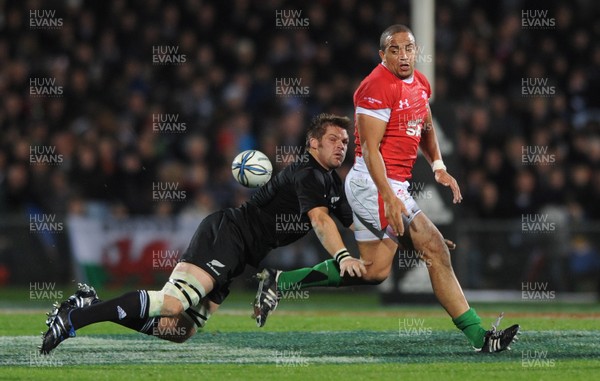 19.06.10 - New Zealand v Wales - 2010 Steinlager Series - Gavin Thomas of Wales is tackled by Richie McCaw of New Zealand. 