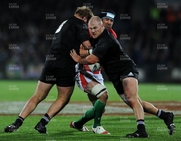 19.06.10 - New Zealand v Wales - 2010 Steinlager Series - Jonathan Thomas of Wales is tackled by Owen Franks and Ben Franks of New Zealand 