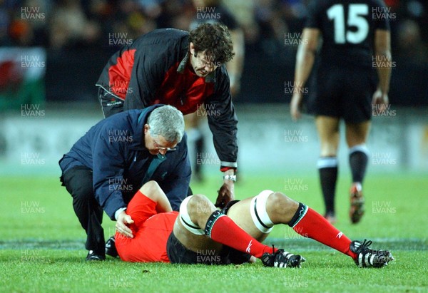 210603 - New Zealand v Wales - Wales Tour of Australasia - Wales' Colin Charvis lays on the floor injured as the team doctor Roger Evans and Physio Mark Davies attend