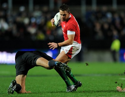 26.06.10 - New Zealand v Wales - 2010 Steinlager Series - Lee Byrne of Wales tries to break a tackle. 